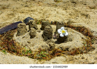 Child's Sand Castle/village On The Beach With Sea Grass Moat And Plumeria Flower Flag