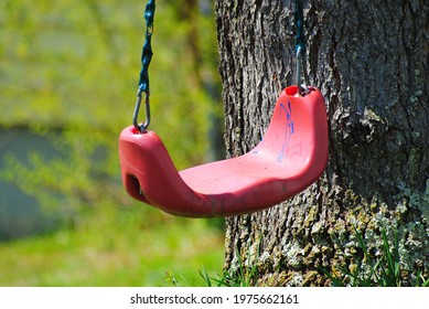 A Child's Swing Sits All Alone, Unused Until The Next Play Time.