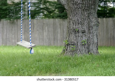 Child's swing in a yard with a tree