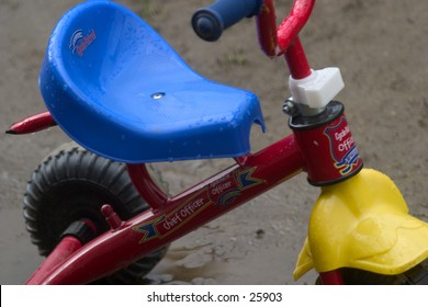 Child's tricycle, left in the rain.