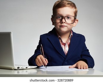 Child.Young Business Boy In Office. Funny Kid In Glasses Writing Pen