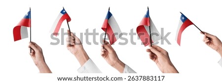 The Chile flag in hand in different angles on a white background