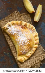 Chilean Apple Empanada With Icing Sugar, Photographed Overhead On Slate With Natural Light