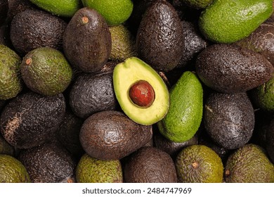 Chilean Hass Paltas, top view image of a group of Hass and Fuerte paltas with a cut palta, representing local production and typical Chilean foods