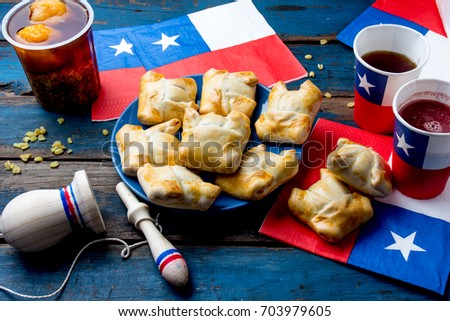 Chilean independence day concept. fiestas patrias. Chilean typical dish and drink on independence day party. Mini empanadas, mote con huesillo, wine with toasted flour chicha and tipical play emboque.