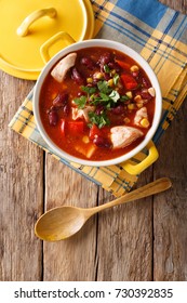 Chili Chicken With Red Beans, Corn And Tomatoes Close-up In A Bowl On The Table. Vertical Top View From Above
