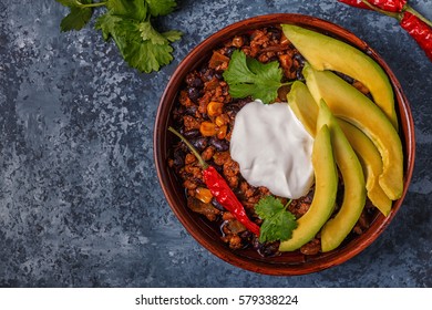 Chili Con Carne In Bowl With Avocado And Sour Cream, Top View.