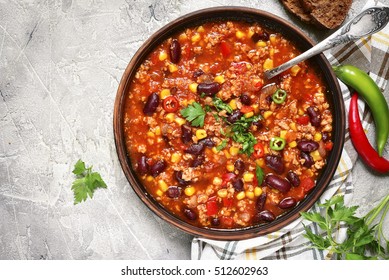 Chili Con Carne In A Clay Bowl On A Concrete Or Stone Rustic Background- Traditional Dish Of Mexican Cuisine.Top View.