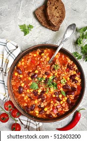 Chili Con Carne In A Clay Bowl On A Concrete Or Stone Rustic Background- Traditional Dish Of Mexican Cuisine.Top View.