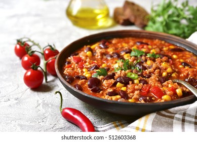 Chili con carne in a clay bowl on a concrete or stone background- traditional dish of mexican cuisine. - Shutterstock ID 512603368