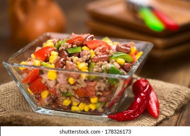 Chili Con Carne Salad Made Of Mincemeat, Kidney Beans, Green Bell Pepper, Tomato, Sweet Corn And Red Onions Served In Glass Bowl (Selective Focus, Focus In The Middle Of The Salad)