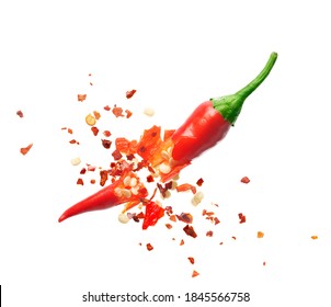 Chili flakes bursting out from red chili pepper over white background - Shutterstock ID 1845566758