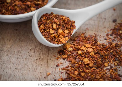 Chili Flakes On Wooden Table