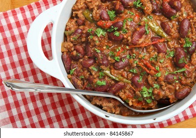 Chili With Ground Beef In An Enameled Casserole Dish.