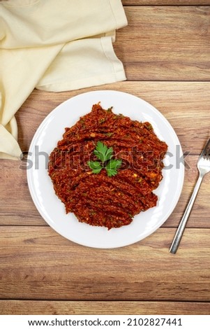 Chili paste on a wooden background. spicy paste. A kind of adjika. Turkish cuisine appetizers. Top view. Close up Stok fotoğraf © 