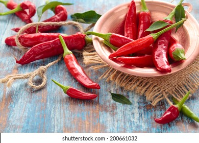 Chili peppers in a copper plate.  - Powered by Shutterstock