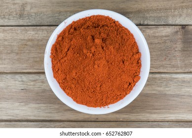 Chili Powder In White Bowl On Wooden Table