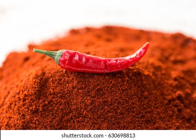 Chili Red Hot Pepper, Concept Of Popular Spice - Delicious Juicy Pod Of Chili Red Pepper Is Isolated On Top Of Red Curry Powder, Ground Dried Idnian Famous Blend