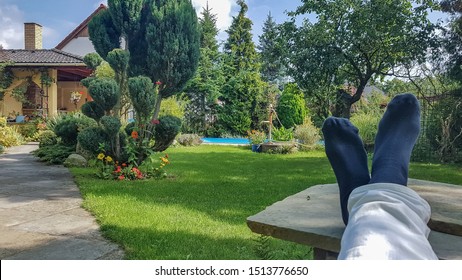 Chill In Nature. Relax In Garden With Foots On Table.