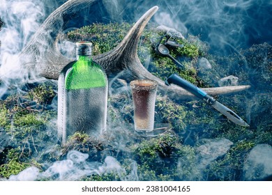 Chilled drink and glass. The bottle and glass are covered with frost. Needles and smoke. Composition of alcoholic drink.