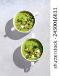 Chilled Summer Pea Soup with Croutons, Sour Cream, Mint, Pea Shoots, and Green Parsley Oil. Vegetarian Food Concept. Handmade Photo, Not AI