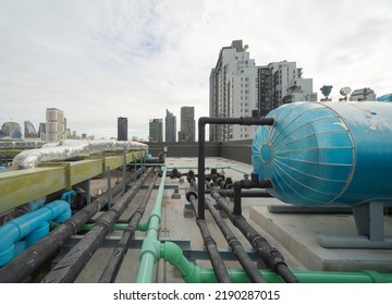 Chiller Tower Or Cooling Tower On Rooftop Of A Office Building In Urban City. System Work. Architecture Machine. Condenser Water Supply And Condenser Water Return Pipe Lines. Ventilation Compressor.