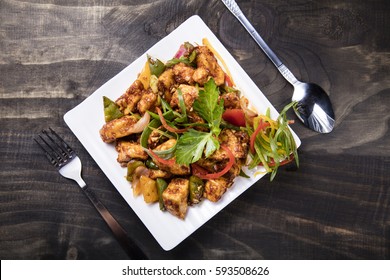 Chilli Paneer Placed On A White Plate