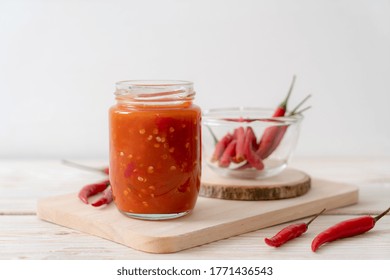 Chilli Or Chilli Sauce In Bottle And Jar On Wwod Background