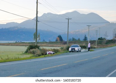 CHILLIWACK, BC - NOVEMBER 2, 2019: An RCMP Patrol Car Is Parked Beside A Single Vehicle Accident Near Chilliwack, BC, Canada On November 2, 2019. 