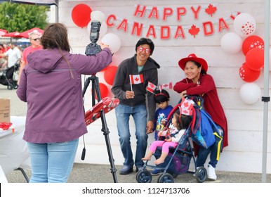 CHILLIWACK, BC/Canada - July 1, 2018: A young family poses for an official photograph during Canada's 151st birthday celebrations in Chilliwack, British Columbia on July 1, 2018.