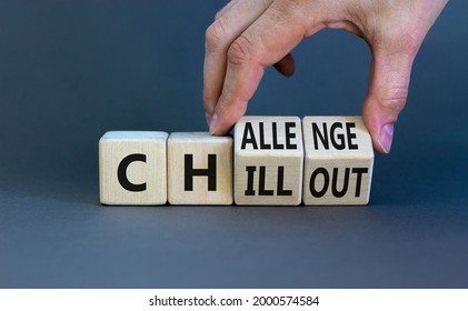 Chillout or challenge symbol. Businessman turns the wooden cube and changes the word chillout to challenge. Beautiful grey background. Business and chillout or challenge concept. Copy space.