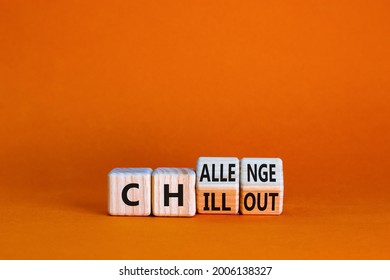 Chillout or challenge symbol. Turned the wooden cube and changed the word chillout to challenge. Beautiful orange background. Business and chillout or challenge concept. Copy space.