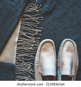 Chilly Weather Clothing Flat Lay With Beige Pashmina Shawl Decorated With Tassels, Beige Mocassins And Grey Cashmere  Jumper