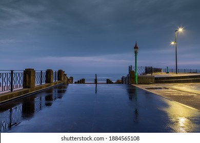 A chilly and wet start at Whitley Bay Promenade, with the railings and street lights reflecting on the wet pavements during Blue hour
