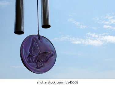 Chimes And Sun Catcher Butterfly Image Against Blue Sky