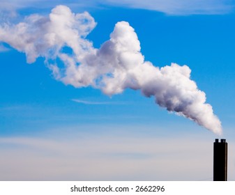 Chimney Billowing White Smoke Into Blue Sky