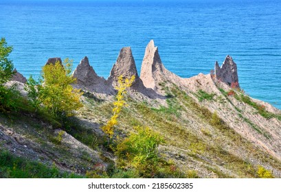 Chimney Bluffs State Park, New York. It’s situated on the southern shore of Lake Ontario, east of Sodus Bay. From the park's hiking trails, you can view the large clay formations at the water's edge - Shutterstock ID 2185602385