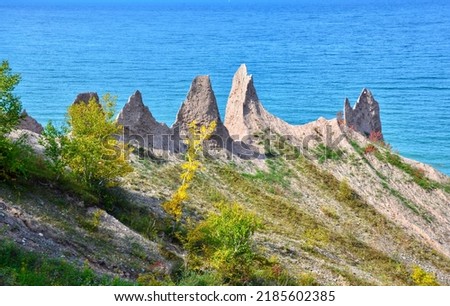 Chimney Bluffs State Park, New York. It’s situated on the southern shore of Lake Ontario, east of Sodus Bay. From the park's hiking trails, you can view the large clay formations at the water's edge