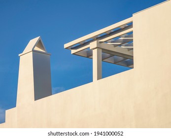 Chimney And Decorative Roof Extension On A Contemporary Concrete House In Local New Urbanist Architectural Style, Alys Beach, Florida, USA, In Late Afternoon Sunlight