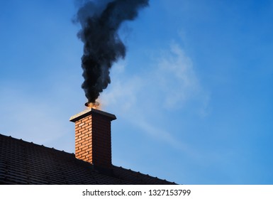 Chimney On Fire With A Black Smoke Coming Out.