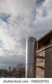 Chimney On The Flat Roof Off A Big Building In The City With A Plume Of Smoke