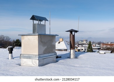 Chimney On A Private House On Flat Roof Covered With Snow In The Winter Season.  Bitumen Asphalt Membrane On Roof 