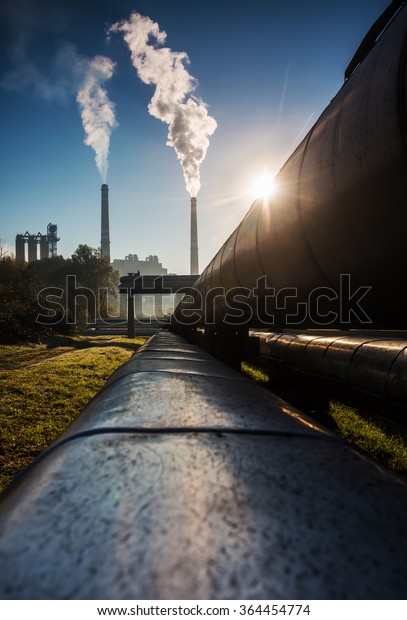 Chimney of power station with\
steam