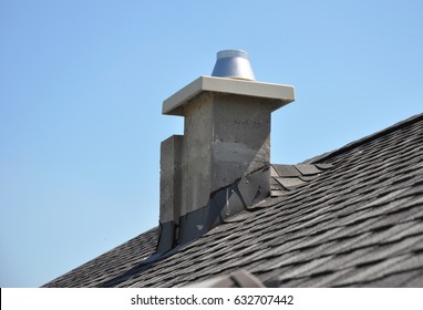 Chimney Repair and Waterproofing asphalt shingles. New modular pumice chimney installation on the house roof. Chimney Linings. Pumice chimney liners.