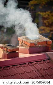 Chimneys. Winter is coming. Smoke and tin roof. Part of house.