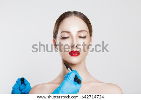 Chin reduction augmentation double chin removal plastic surgery cosmetic operation concept Woman eyes closed waiting doctor surgeon hands to draw the cut line the double chin isolated white background