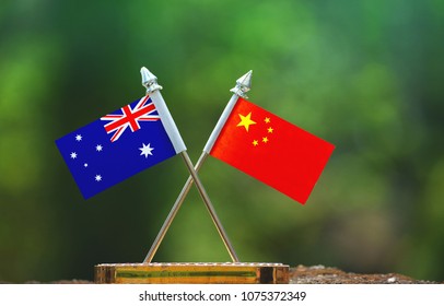 China And Australia Small Flag With Blur Green Background