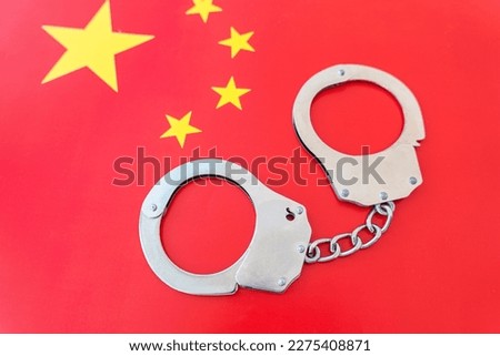 China flag and police handcuffs. The concept of observance of the law in country and protection from crime
