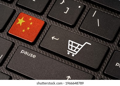China flag and White Trolley or shopping cart icon print screen on button computer laptop keyboard , Shopping online and e-commerce concept.