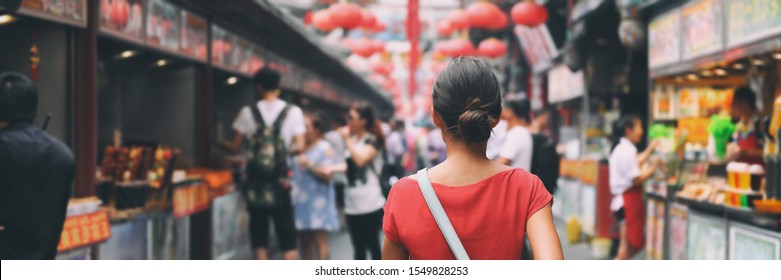 China food market street in Beijing. Chinese tourist walking in city streets on Asia vacation tourism. Asian woman travel lifestyle panoramica banner.